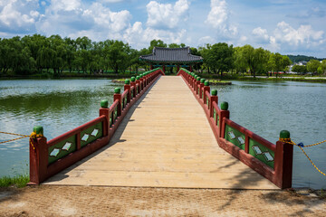 Naklejka premium Traditional Wooden Bridge and Pavilion at Gungnamji Pond in Buyeo, Korea