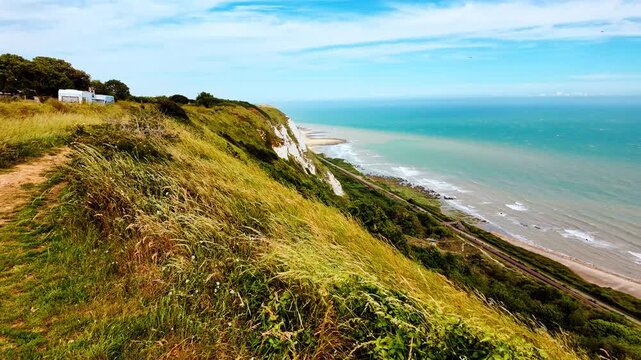 Rugged coast and railway line, Folkestone, Kent, England, UK, with chalk cliffs, sea views and tracks curving along the shoreline