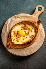 Traditional Georgian Adjaruli khachapuri with egg and cheese