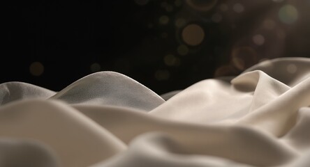 Soft, flowing fabric textures with light bokeh effects