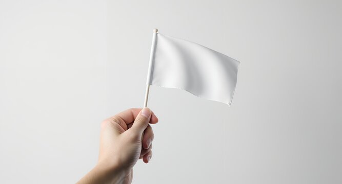 A hand holding a blank white flag on a stick against a white background.