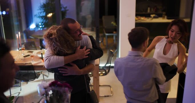Friends Arrive at a Dinner Party with Gifts and Flowers, Greeting the Hosts with Warm Hugs and Happy Smiles