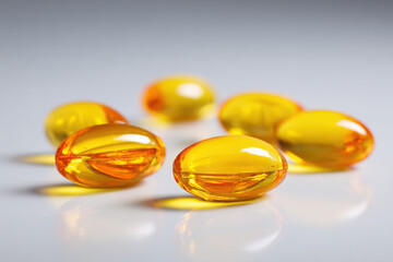 Close-up view of several yellow vitamin capsules