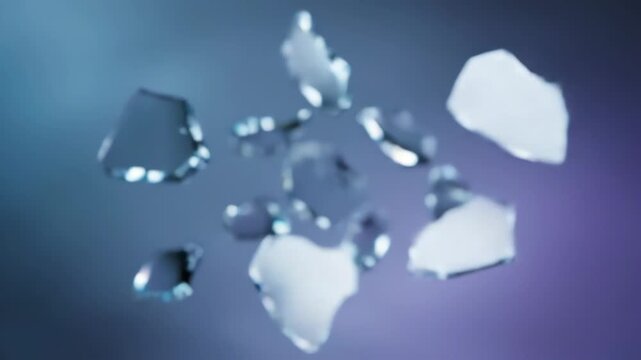 Shimmering shards of ice or glass dynamically float against a vibrant blue and purple gradient background.