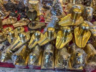 Multiple brass Shivlings, used for worship in homes and temples. Sell store