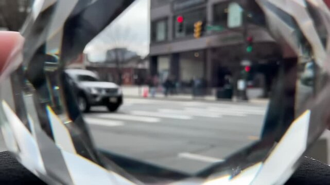 City street scene reflected in multifaceted crystal object