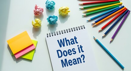 What does it mean written on a notebook with colorful pencils isolated on white background