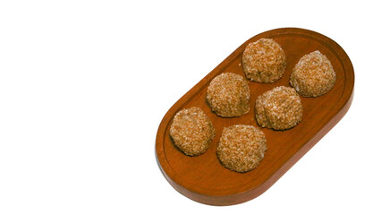Mochi, a sweet dessert or rice cake filled with chocolate or mung beans, and coated with sesame seeds Mochi cake on a plate with a white background.