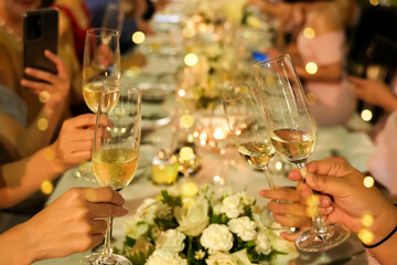 Wedding, couple at celebration party with friends and family, happy and smiling toasting champagne glasses, happy celebration concept.