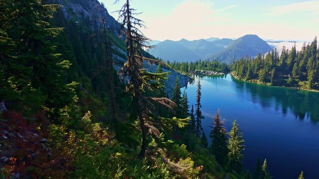 A breathtaking view of the vibrant blue waters of Lake Valhalla, nestled amidst the stunning wilderness of Washington and part of the iconic Pacific Crest Trail