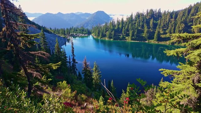 A breathtaking view of the vibrant blue waters of Lake Valhalla, nestled amidst the stunning wilderness of Washington and part of the iconic Pacific Crest Trail