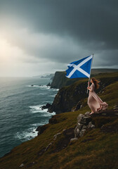 Woman holding the Scottish flag on a dramatic cliff overlooking the sea. Vertical photo of a person celebrating national pride in the highlands. Freedom and travel in Scotland concept