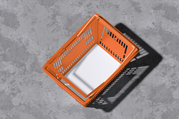 White flyer on grocery basket with concrete background for mockup template
