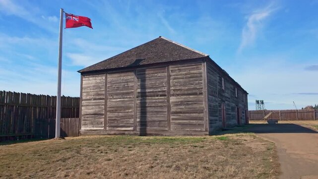 A scenic view of Fort Vancouver, a former fur trading post, showcasing its reconstructed stockade and historical buildings under a clear sky