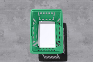 White A4 flyer on green grocery basket with concrete background for mockup template