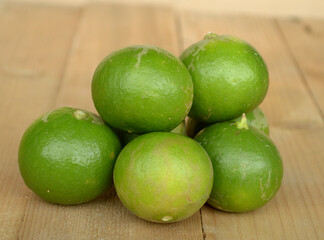 fresh lime fruit on wood background