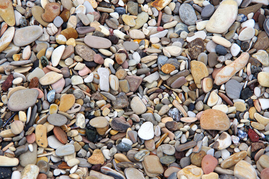 Multicolored pebbles on the beach - Powered by Adobe