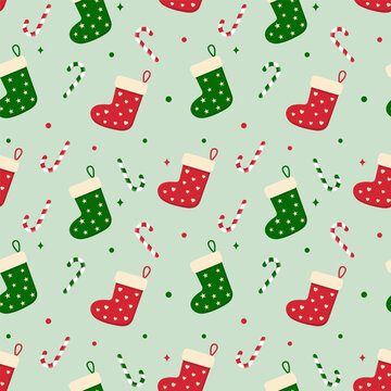 Seamless pattern with Christmas socks.Xmas repeat pattern with colorful stocking in red and green isolated on light green background.Vector graphic illustration wallpaper.
