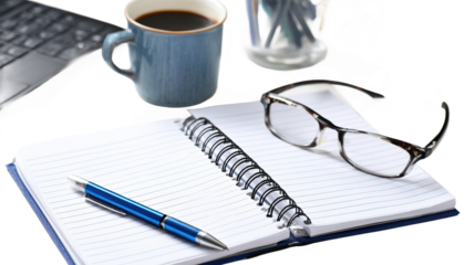 Coffee, notebook, and glasses on a desk.