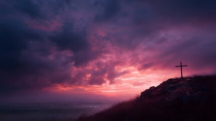 A solitary cross stands silhouetted on a rocky hilltop against a dramatic vibrant sunset sky filled with purple and pink clouds