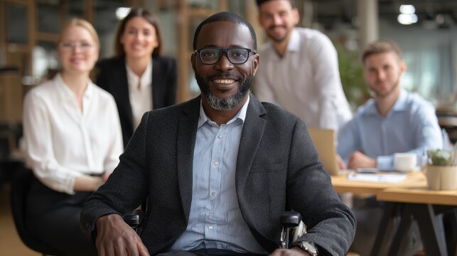 A wheelchair using entrepreneur is supported by coworkers in a contemporary office highlighting teamwork inclusivity and resilience against difficulties