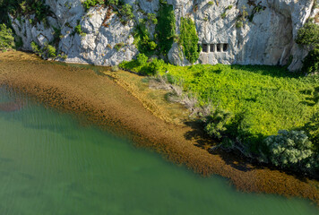 A rocky cliff with ancient Asarkale rock tombs in Bafra, Samsun, Türkiye. Ancient columns carved into the rock. Tourist attractions,