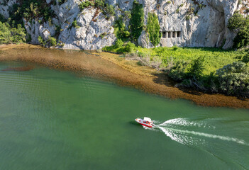A rocky cliff with ancient Asarkale rock tombs in Bafra, Samsun, Türkiye. Ancient columns carved into the rock. Tourist attractions,
