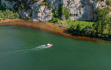 A rocky cliff with ancient Asarkale rock tombs in Bafra, Samsun, Türkiye. Ancient columns carved into the rock. Tourist attractions,