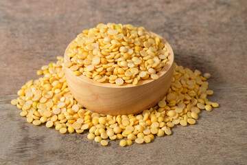 Split soybeans in a wooden cup and on a wooden table. Healthy food concept.