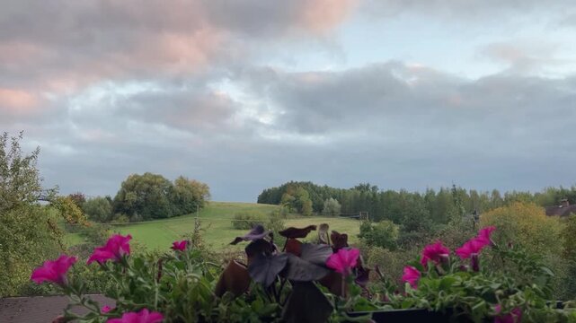 Time-lapse video of clouds moving across the sky with changing weather over hills and trees. Atmospheric natural landscape footage perfect for climate, nature, and cinematic background concepts.
