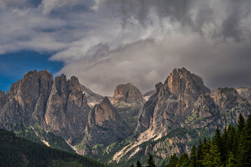 Fototapeta premium moutain Catinaccio range seen from Pozza di Fassa with a cloudy sky in the background, Val di Fassa, Trento, Italy