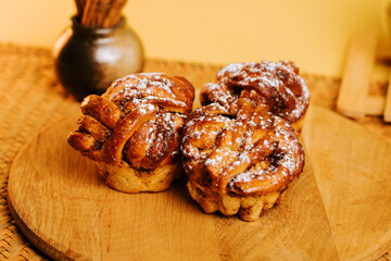 Freshly baked sweet pastries on a wooden board in a cozy kitchen setting
