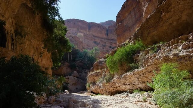 A high definition video of the scenic Wadi Shab, a popular outdoor destination in Oman's Al Sharqiyah region. The footage captures the rugged beauty of the rocky canyon, with its towering cliffs, scat