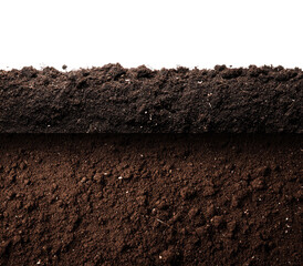 Fototapeta premium Close-up view of two layers of dark brown soil. The top layer is slightly uneven, with a rough texture visible. The bottom layer shows a similar texture, but is a bit darker. 