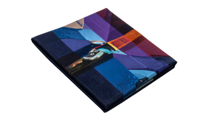 Colorful abstract pattern on a dark, folded, square fabric piece