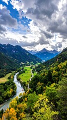 Verdant valley with river, mountains, and dramatic cloudy sky