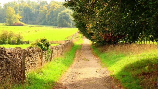 Scenic country path in the Cotswolds, England. Cotswolds countryside, England
