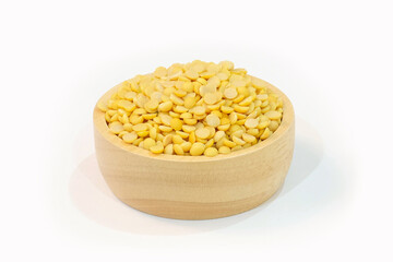 Split soybeans in a wooden cup and on a wooden table. Healthy food concept.