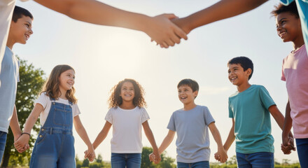 Obraz premium Group of diverse children holding hands in a circle, symbolizing unity and friendship under a bright sky.