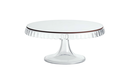Clear glass cake stand with a ruffled edge, isolated on black