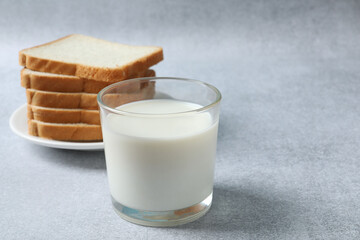 glass of milk, bread on the background
