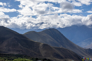Majestic mountain landscape of Mustang, Nepal, with rolling brown hills under a dramatic sky. Ideal for travel magazines, adventure posters, tourism branding, environmental education, and wall art.
