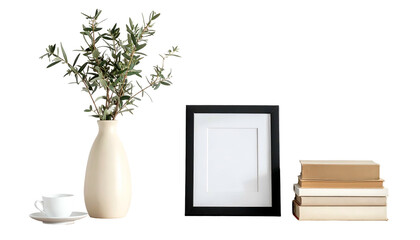 A still life setup shows an olive branch in a vase, a framed blank print, books, and a cup