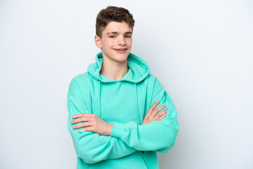 Teenager Russian man isolated on white background keeping the arms crossed in frontal position
