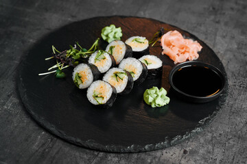 Close up sushi rolls with sesame and herbs