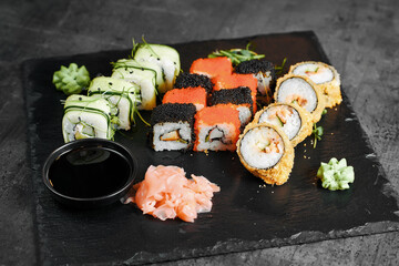 Assorted sushi rolls with ginger and wasabi top view
