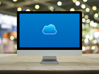 Cloud computing flat icon on modern computer monitor screen on wooden table over blur light and shadow of shopping mall, Technology cloud computing concept
