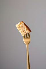 Minimalist Plain Cake Slice Floating on a Golden Fork, Abstract Food Art