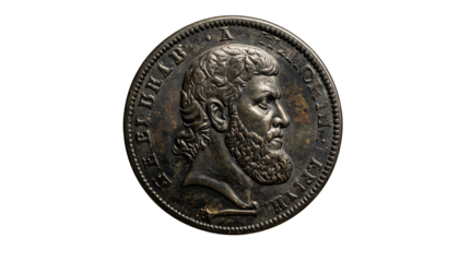Antique coin with bearded profile, inscribed around rim
