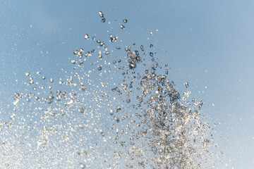 Splashes and jets of water against light background.